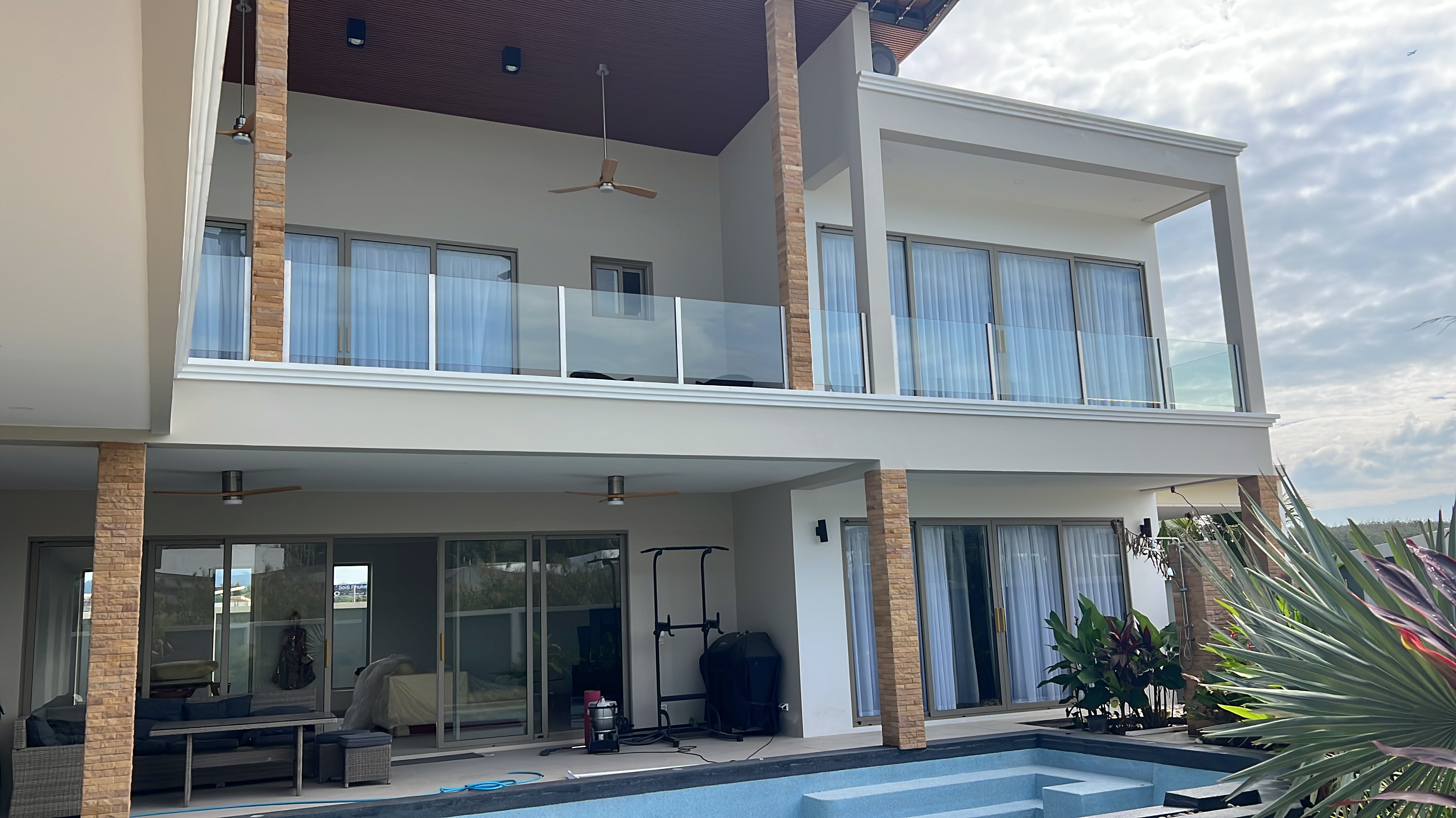 Rear elevation with glass-balustrade balconies and private pool